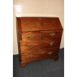 A George III mahogany bureau with pigeon holes and four drawers inside drop flap, over two short and