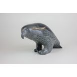 An Inuit hardstone carving of a bird with a hooked beak, marks to base identifying the artist as