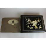 An early 20th century Chinese black lacquered postcard album, including  postcards with views of the