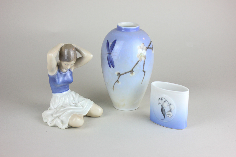 A Royal Copenhagen porcelain figure of a seated girl tying her hair, 12cm, a vase 14cm, and a