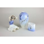 A Royal Copenhagen porcelain figure of a seated girl tying her hair, 12cm, a vase 14cm, and a