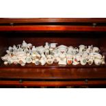 A large collection of approximately sixty Goss and similar crested china including vases,