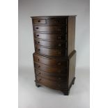 A miniature mahogany chest on chest of two short over four long drawers above four long drawers,