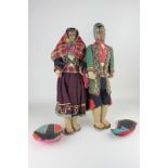 Two South American dolls with painted composite heads on cloth bodies in traditional dress, 41cm