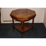 An Edwardian inlaid walnut octagonal table, with foliate border, on turned legs with undershelf,