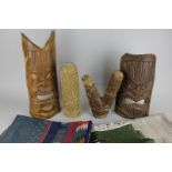 Four Tongan wood masks and carvings together with three small woven rugs