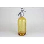 An amber glass Schweppes porcelain lined siphon with engraved detail, 30cm high