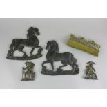 A pair of metal mounts in the form of horses, 17cm, two brass figures and another mount with a row