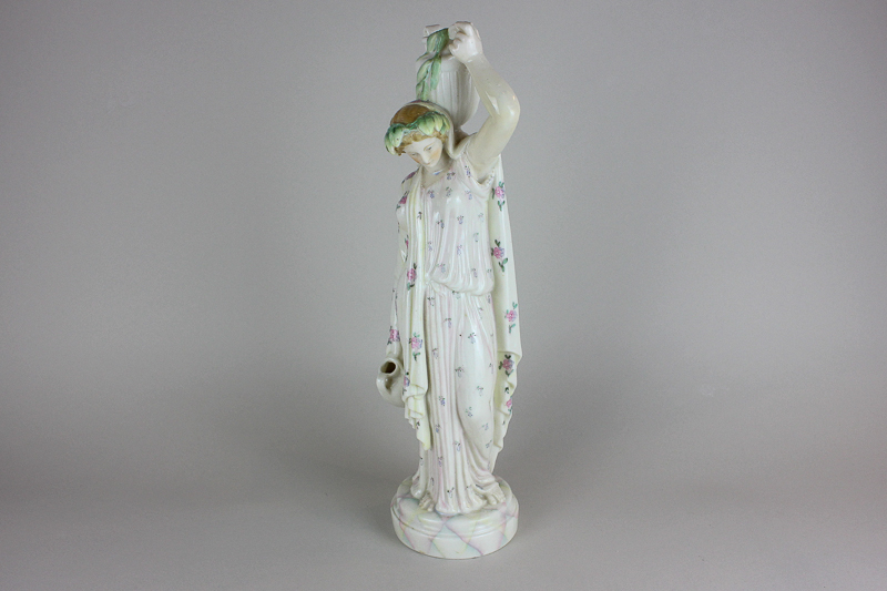 A marbled effect porcelain figure of a classical lady carrying water pitchers, 38cm high