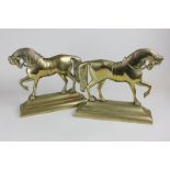 A pair of brass door stops modelled as horses