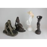 Two resin figures of partially nude women, a resin figure of a man feeding birds and a Franklin Mint