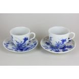 A pair of Japanese porcelain blue and white tea cups with floral decoration, character marks to