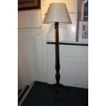 A mahogany standard lamp with facetted baluster stem, on tripod base