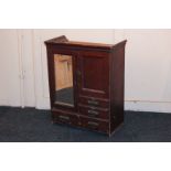 A Victorian miniature wardrobe with mirrored door, cupboard and three drawers, 60cm high