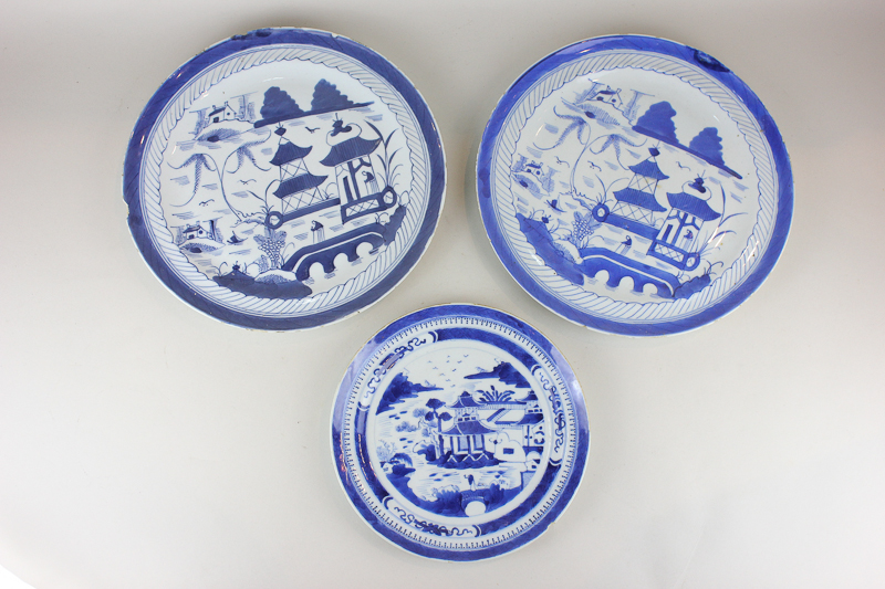 A pair of Chinese blue and white plates depicting a landscape, 29cm diameter, and another smaller