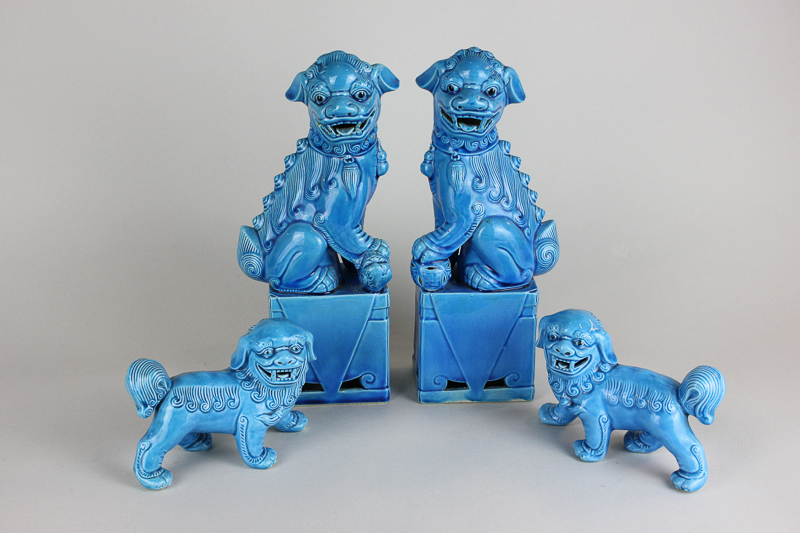 Two pairs of Chinese porcelain temple dogs, both in blue glaze, largest 25cm high