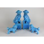 Two pairs of Chinese porcelain temple dogs, both in blue glaze, largest 25cm high