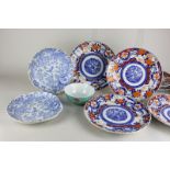 A set of eight Imari porcelain dishes, with scalloped borders 22cm, and two shell shape blue and