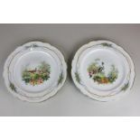 A pair of European porcelain cabinet plates, hand painted with birds in a landscape, with gilt