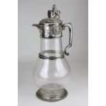 A 19th century silver plate mounted glass claret jug with lion and shield finial and mask