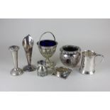 A silver plated sugar bowl with blue glass liner, two bud vases, a tankard, a strainer, a vase and a