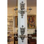 A set of four impressive Baroque style silver plated wall lights, with three scroll branches on