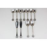 A set of seven George VI silver coffee spoons with oval terminals bearing the head of a terrier dog,