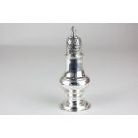 A George III silver spice caster, baluster shape with pierced lid and finial, maker Thomas Daniel,