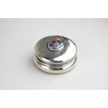 A Liberty & Co Cymric silver and enamel dressing table box, circular shape, top with central