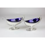 A pair of George III neo-classical style silver salts, oval urn shape with twin handles and blue