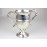 A George III silver two handled loving cup with scroll handles and reeded girdle on circular