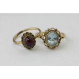 An aquamarine ring in 9ct gold and a cabochon ruby ring in 9ct gold