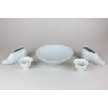 A Chinese celadon pottery bowl, two shoe pots and a pair of porcelain flower head bowls, character