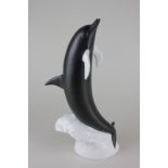 A Royal Dux Bohemia porcelain model of a dolphin in black matte and white gloss finish, 36cm high