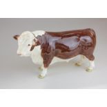 A Beswick Polled Hereford bull, model 2549A in brown and white gloss, with ringed nose