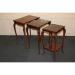 A nest of three mahogany occasional tables on shell carved slender cabriole legs, the smallest table