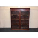 A 19th century mahogany bookcase top with twin panel glazed doors enclosing three shelves, 112.5cm