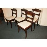 A set of four 19th century carved mahogany dining chairs with scroll bar backs, upholstered drop-