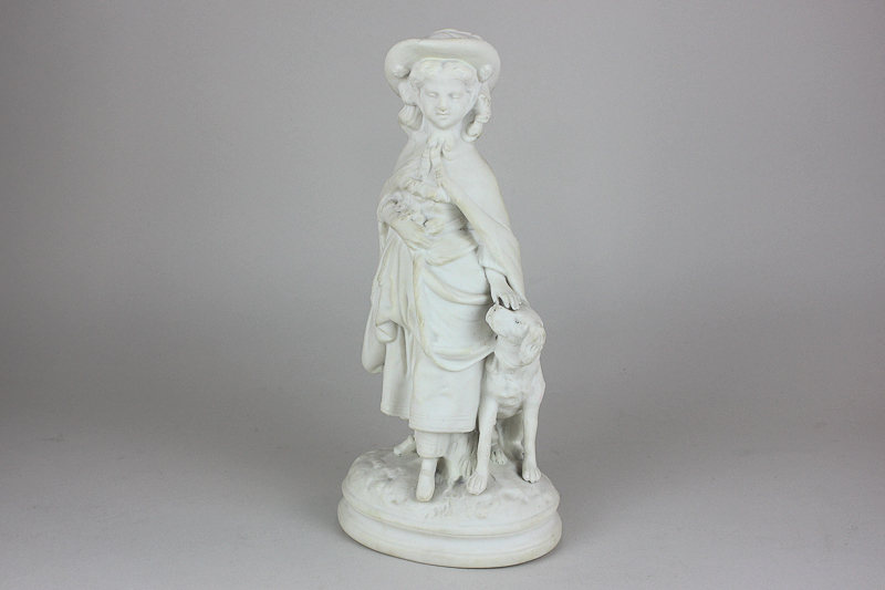 A bisque porcelain figure of a girl in Victorian dress with a seated dog, 30cm