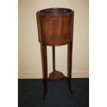 An Edwardian inlaid mahogany jardiniere of cylindrical form, with liner, on outswept legs, 97cm