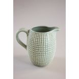 A Clarice Cliff pottery jug with green sweet corn decoration and overlaid flower design by handle,