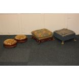 A pair of circular inlaid mahogany foot stools with padded tops and two square tapestry