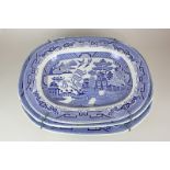 A pair of blue and white willow pattern serving platters, 52cm, and another slightly smaller, 46cm