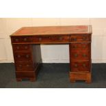 A Victorian mahogany pedestal desk with leather inset top above an arrangement of drawers, on