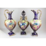 A Victorian china set of two ewers and a vase and cover with gilt scroll handles, decorated with