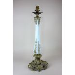 A brass mounted opaque glass table lamp with faceted stem on pierced scroll base, 53cm high