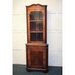 A Georgian style walnut corner cabinet with panel glazed top on base with cupboard, 66cm
