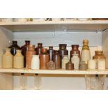 A collection of approximately twenty stoneware bottles and jars, including Bourne, Denby,