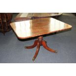 A 19th century banded mahogany breakfast table, with rectangular tilt-top on turned pedestal,