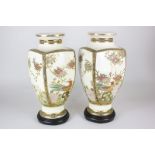 A pair of Japanese Satsuma pottery vases with crackle glaze and gilt and floral design, on wooden